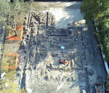 Spacious modern kitchen with white cabinets and island in natural light.